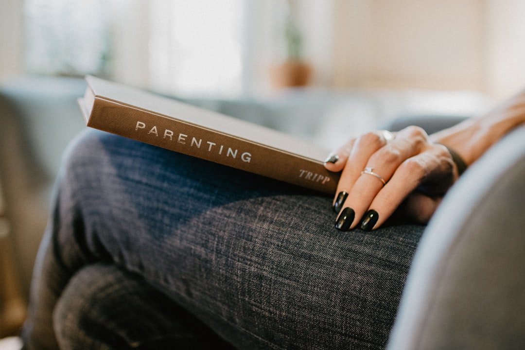 Parenting book on a womans lap